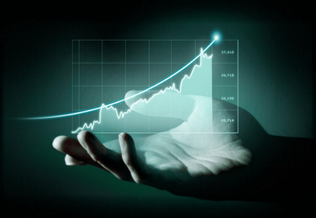 A digital composite image shows a hand held open against a dark background with a glowing, upward-trending graph hovering above it. The graph includes labeled tick marks indicating numeric data points, symbolizing financial growth. This image represents the increasing profit margins achievable by telecom resellers through effective billing solutions and adherence to regulatory compliance standards.